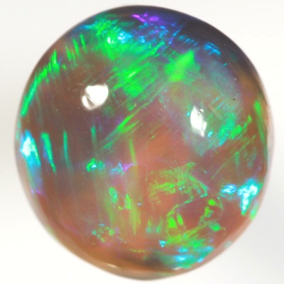 SOLID BLACK CRYSTAL OPAL Rolling flashes of green over purple fire